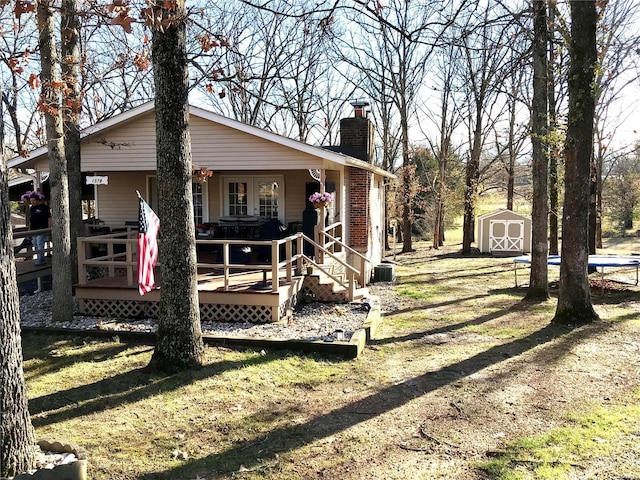 1578 Lakeshore, Cuba, MO 65453 - view of home's exterior with a chimney, a storage unit, an outdoor structure, and cooling unit