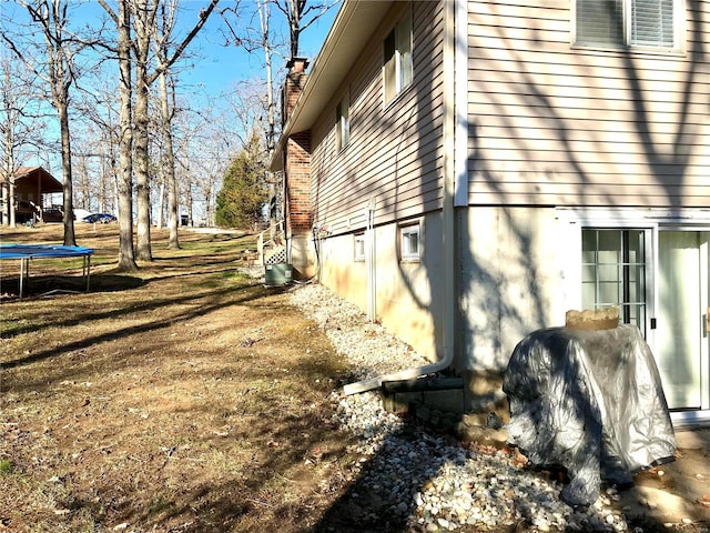 1578 Lakeshore, Cuba, MO 65453 - view of property exterior with a trampoline and a chimney