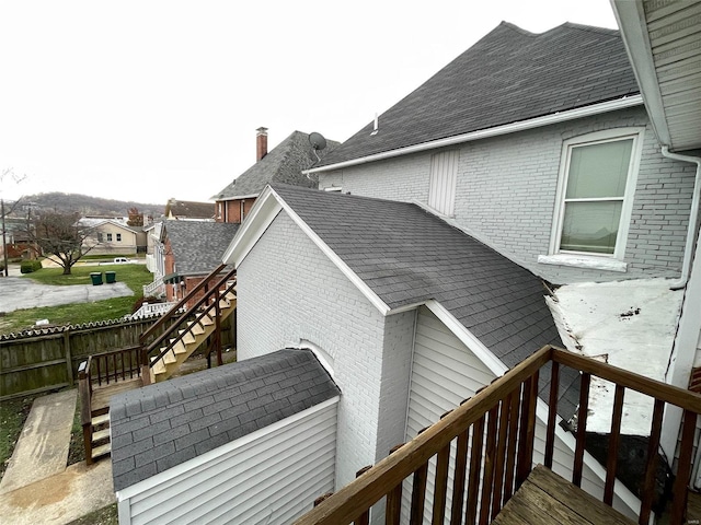 221 N 3rd St Unit 221, Louisiana, MO 63353 - view of property exterior featuring stairway, brick siding, and roof with shingles