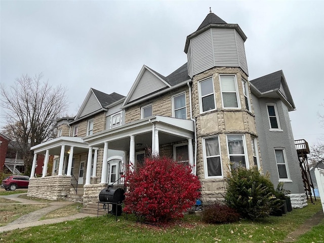 221 N 3rd St Unit 221, Louisiana, MO 63353 - view of front of home featuring a porch, stone siding, roof with shingles, and a chimney