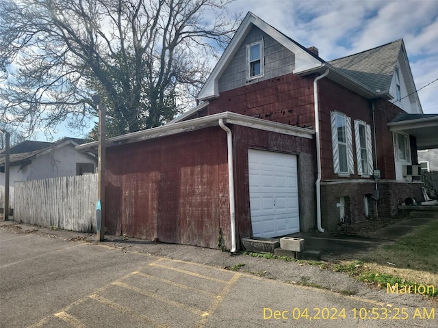 403 E Main St, Marion, IL 62959 - view of property exterior with fence, a shingled roof, a garage, and a chimney