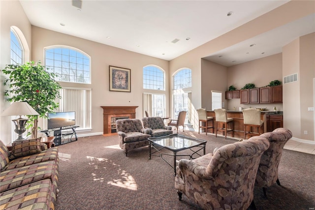 13101 Mill Crossing Ct Unit 307, Creve Coeur, MO 63141 - carpeted living area with a high ceiling, baseboards, plenty of natural light, a glass covered fireplace, and recessed lighting