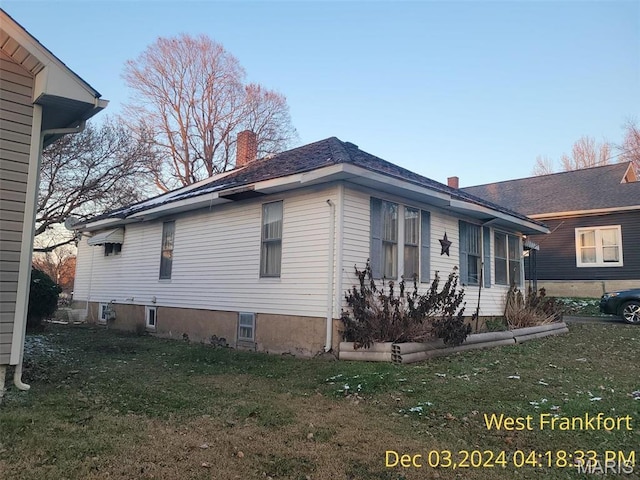 1415 E Oak St, West Frankfort, IL 62896 - view of home's exterior featuring a chimney and a yard