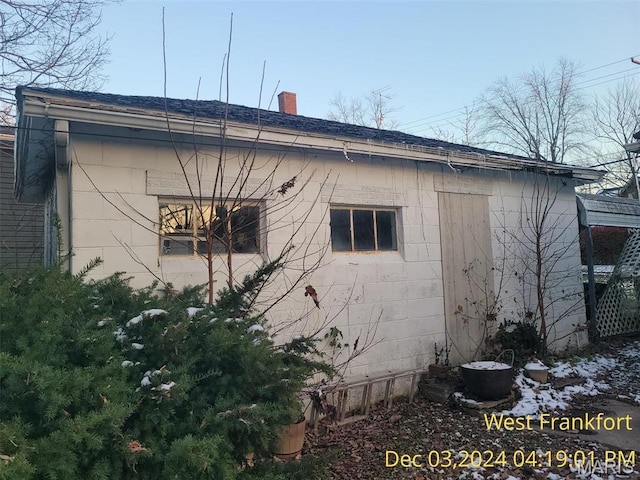 1415 E Oak St, West Frankfort, IL 62896 - view of home's exterior with concrete block siding and a chimney
