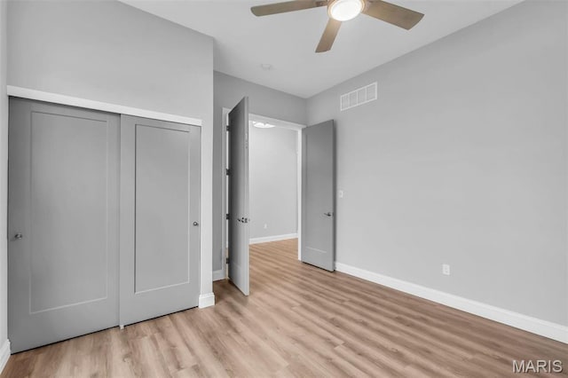201 Keaton Woods Dr, Ofallon, MO 63368 - unfurnished bedroom featuring a closet, light wood-type flooring, baseboards, and ceiling fan