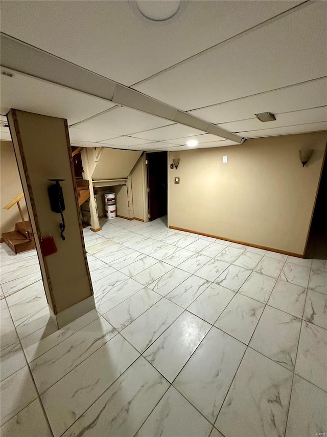 4025 Tholozan Ave, Saint Louis, MO 63116 - finished basement with light marble finish flooring, stairway, and baseboards