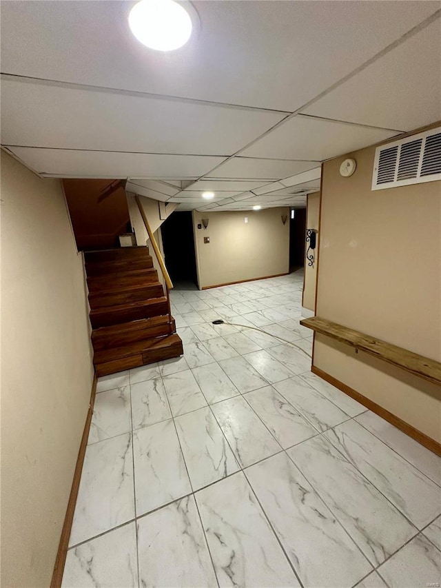 4025 Tholozan Ave, Saint Louis, MO 63116 - finished basement with light marble finish floors, stairway, and baseboards