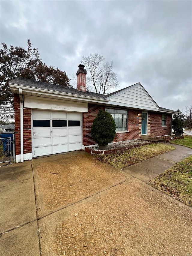 4828 Reavis Barracks Rd, Saint Louis, MO 63123 - single story home with concrete driveway, brick siding, an attached garage, and a chimney