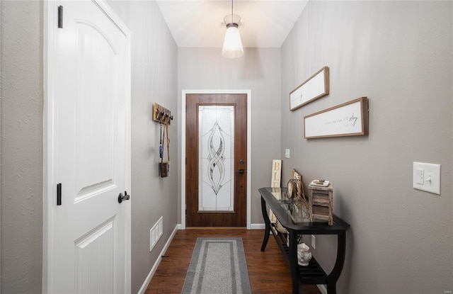 entryway with dark wood finished floors and baseboards