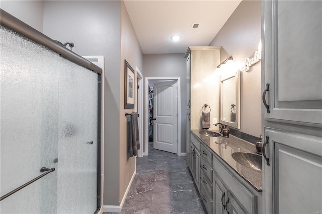 full bathroom with a shower stall, double vanity, marble finish floors, and a spacious closet