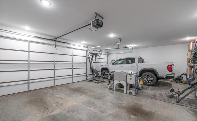 garage featuring a garage door opener and recessed lighting