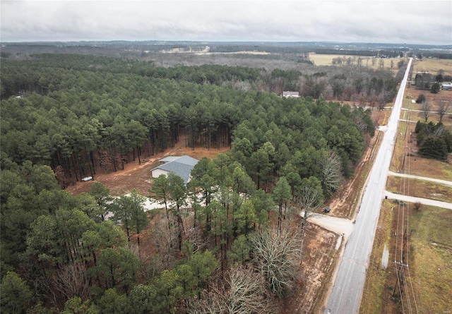 aerial view of property's location with a heavily wooded area