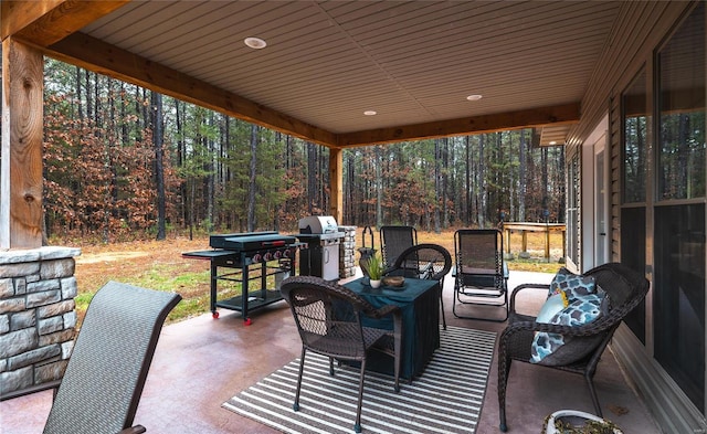 view of patio / terrace featuring area for grilling and a wooded view