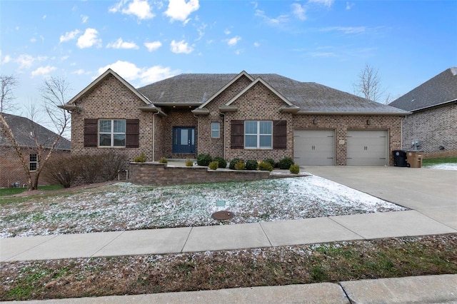 1661 Helmsdale Cpe, Girardeau, MO 63701 - view of front facade with brick siding, a garage, driveway, and roof with shingles