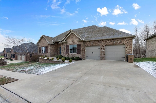 1661 Helmsdale Cpe, Girardeau, MO 63701 - view of front facade with brick siding, a garage, driveway, and a shingled roof