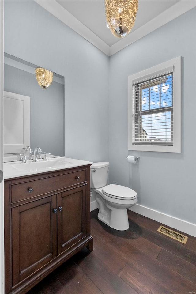 1661 Helmsdale Cpe, Girardeau, MO 63701 - half bath with baseboards, toilet, vanity, and wood finished floors