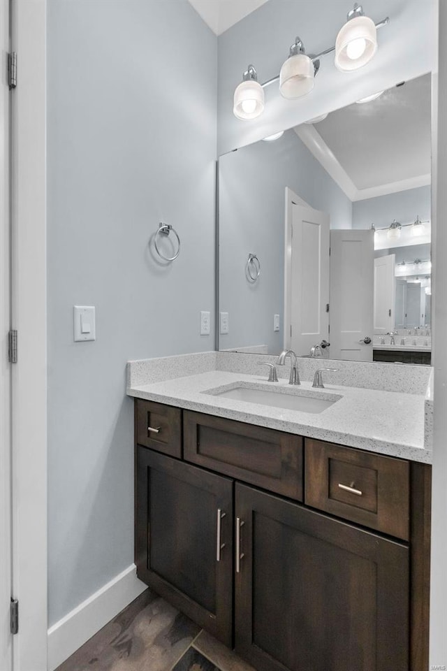 1661 Helmsdale Cpe, Girardeau, MO 63701 - bathroom featuring vanity, baseboards, wood finished floors, and ornamental molding