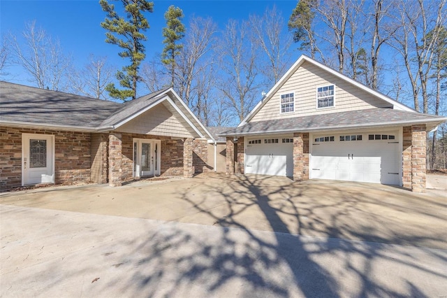 14178 E US Highway 60, Van Buren, MO 63965 - view of front of house with a garage, concrete driveway, stone siding, and a shingled roof