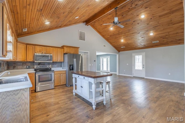 14178 E US Highway 60, Van Buren, MO 63965 - kitchen featuring stainless steel appliances, a sink, a ceiling fan, baseboards, and high vaulted ceiling