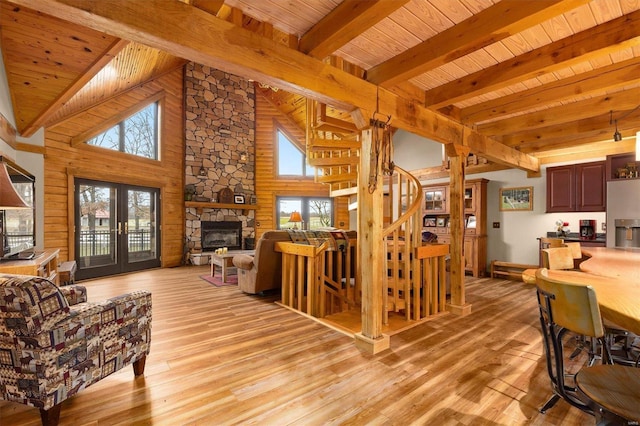 7467 Walshville Trl, Hillsboro, IL 62049 - living room featuring wooden ceiling, a stone fireplace, beamed ceiling, light wood finished floors, and stairway
