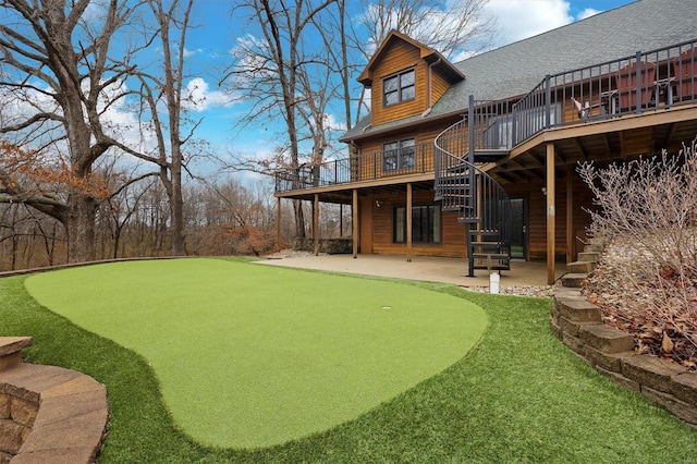 7467 Walshville Trl, Hillsboro, IL 62049 - view of yard featuring a patio area, an area to practice putting, a wooden deck, and stairway