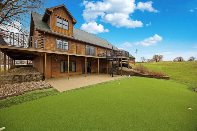 7467 Walshville Trl, Hillsboro, IL 62049 - rear view of house featuring a putting green, a wooden deck, a patio area, stairway, and a lawn