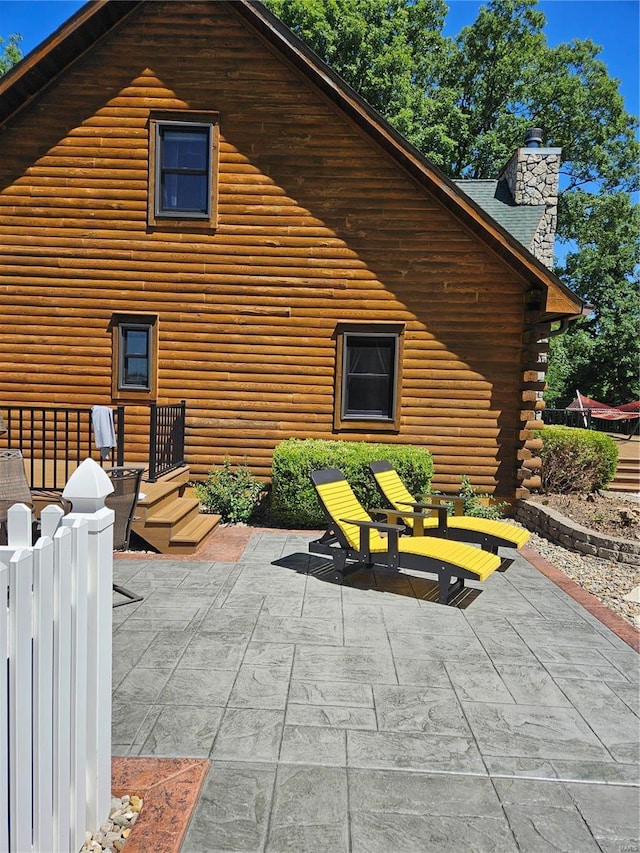 7467 Walshville Trl, Hillsboro, IL 62049 - back of property with a patio area and a chimney