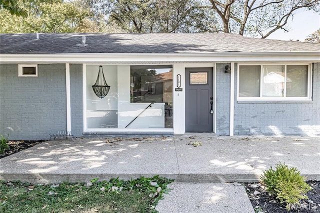 1101 W Parkedge Ln, Saint Louis, MO 63130 - property entrance with brick siding and roof with shingles