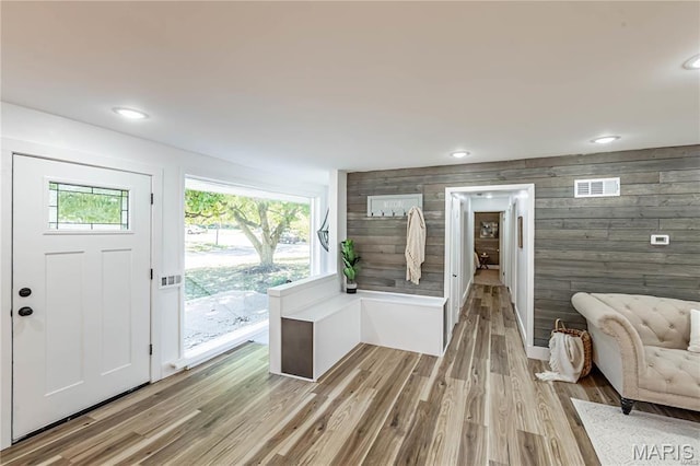 1101 W Parkedge Ln, Saint Louis, MO 63130 - foyer featuring light wood-style floors, wood walls, and recessed lighting