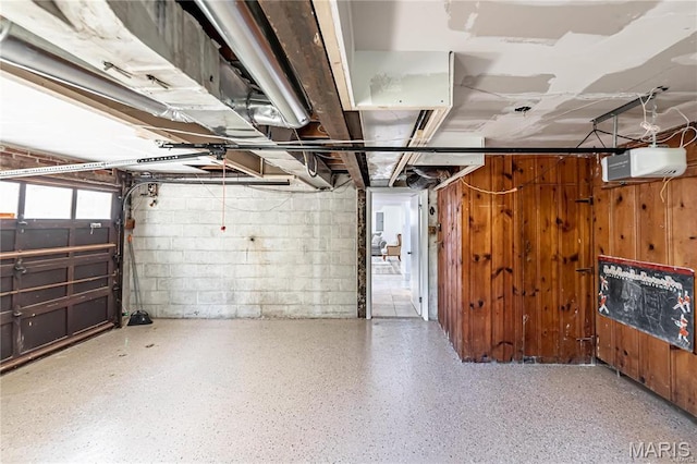 1101 W Parkedge Ln, Saint Louis, MO 63130 - garage with a garage door opener, concrete block wall, and wooden walls