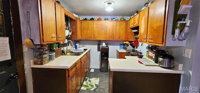 300 S Oak St, Salem, MO 65560 - kitchen with a sink, light countertops, brown cabinets, and dark tile patterned floors