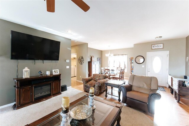 311 Dana Renee, Rolla, MO 65401 - living room with a chandelier, ceiling fan, light wood finished floors, and baseboards