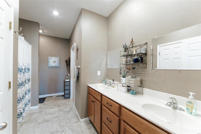 311 Dana Renee, Rolla, MO 65401 - bathroom with double vanity, baseboards, marble finish floors, and a shower with curtain