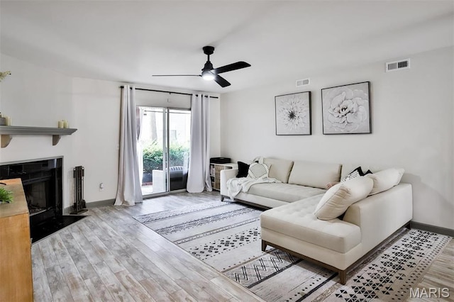 915 Sugar Lake Ct Unit 4, Saint Peters, MO 63376 - living area featuring ceiling fan, wood finished floors, baseboards, and a fireplace with flush hearth