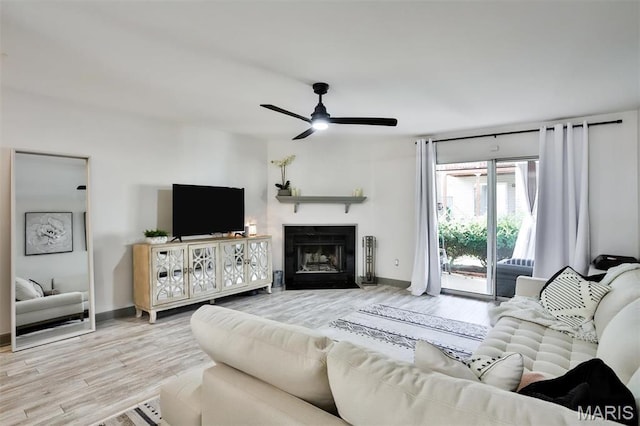 915 Sugar Lake Ct Unit 4, Saint Peters, MO 63376 - living area featuring wood finished floors, ceiling fan, a fireplace, and baseboards