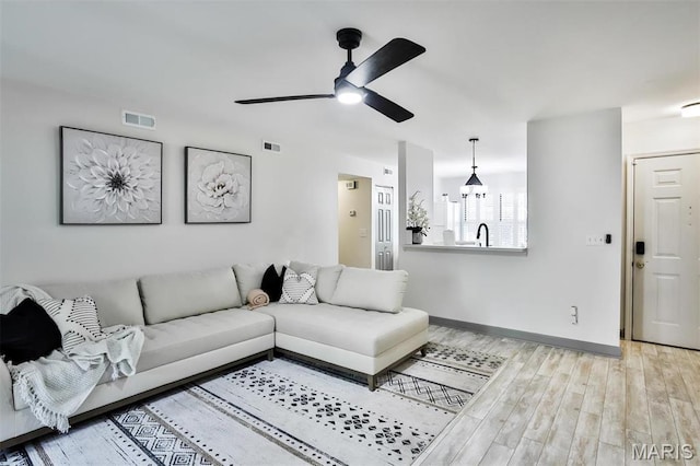 915 Sugar Lake Ct Unit 4, Saint Peters, MO 63376 - living room featuring ceiling fan, light wood-type flooring, and baseboards