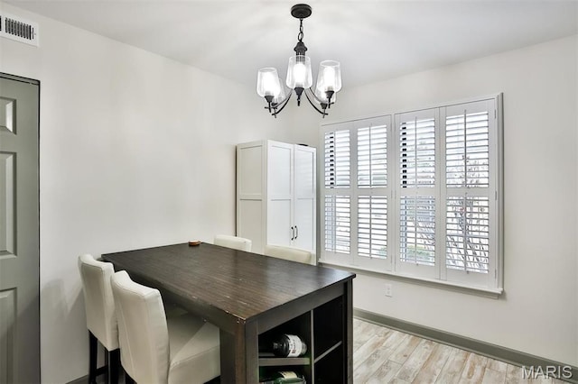 915 Sugar Lake Ct Unit 4, Saint Peters, MO 63376 - dining area featuring a chandelier, light wood-style floors, and baseboards