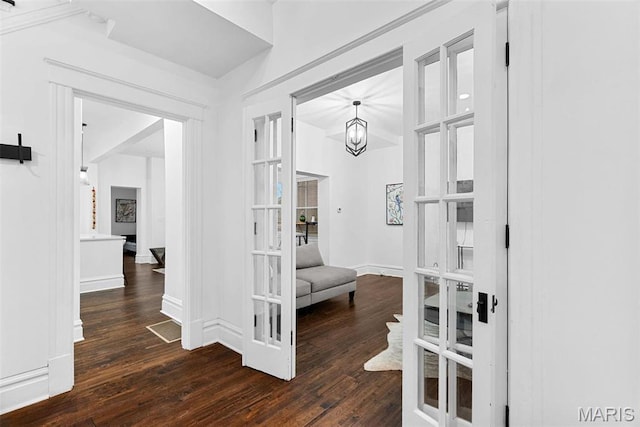 3223 Geyer Ave, Saint Louis, MO 63104 - hall with wood-type flooring, baseboards, and a chandelier