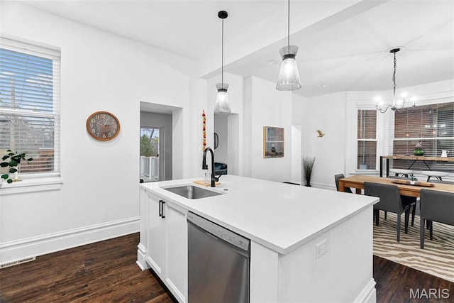3223 Geyer Ave, Saint Louis, MO 63104 - kitchen with stainless steel dishwasher, a sink, dark wood-type flooring, and a chandelier