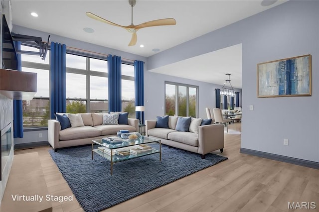 215 Wyndemere Ln, Lake St Louis, MO 63367 - living area featuring wood finished floors, ceiling fan, baseboards, a chandelier, and recessed lighting