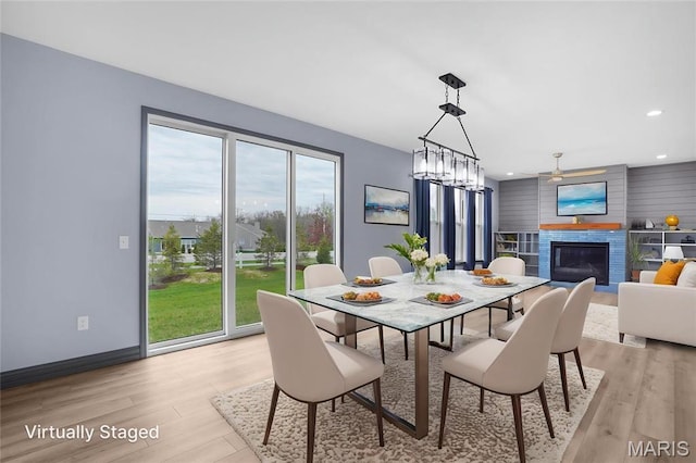 215 Wyndemere Ln, Lake St Louis, MO 63367 - dining area featuring a glass covered fireplace, light wood-style flooring, recessed lighting, a ceiling fan, and baseboards