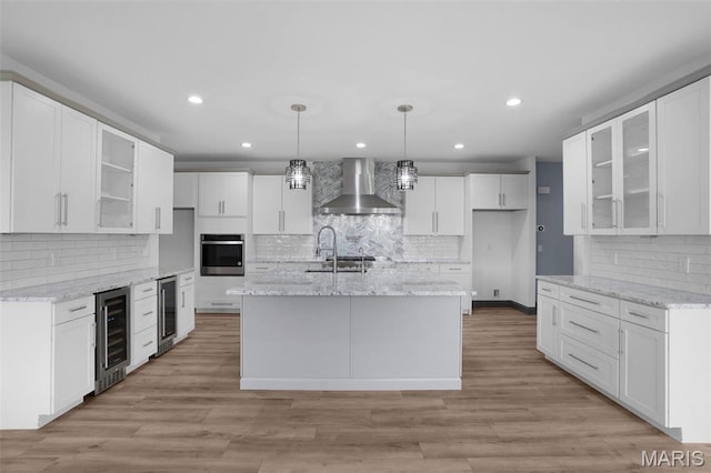 215 Wyndemere Ln, Lake St Louis, MO 63367 - kitchen featuring wall chimney range hood, stainless steel oven, beverage cooler, backsplash, and recessed lighting