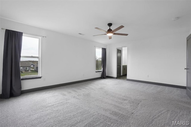 215 Wyndemere Ln, Lake St Louis, MO 63367 - empty room with carpet flooring, healthy amount of natural light, a ceiling fan, and baseboards