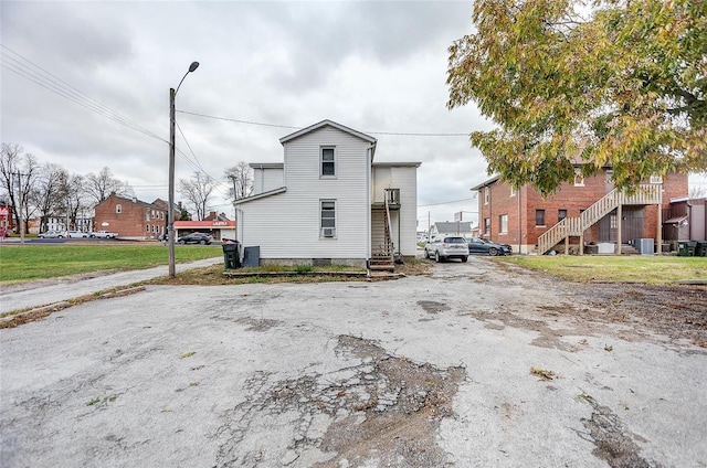 106 N Market St, Waterloo, IL 62298 - view of side of property with stairway and central AC unit