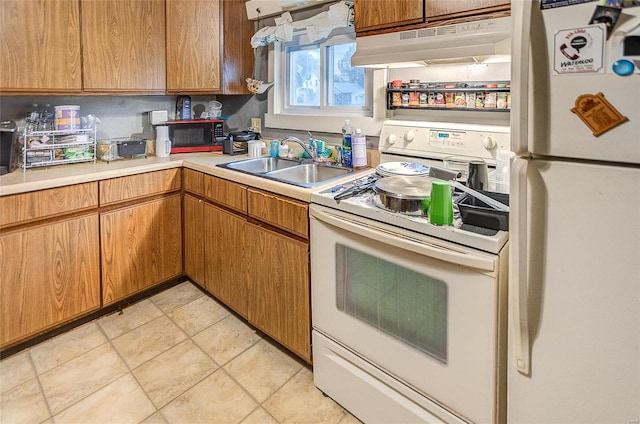 106 N Market St, Waterloo, IL 62298 - kitchen featuring white appliances, under cabinet range hood, a sink, and light countertops
