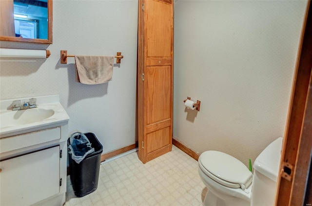 106 N Market St, Waterloo, IL 62298 - half bath with tile patterned floors, toilet, vanity, and baseboards
