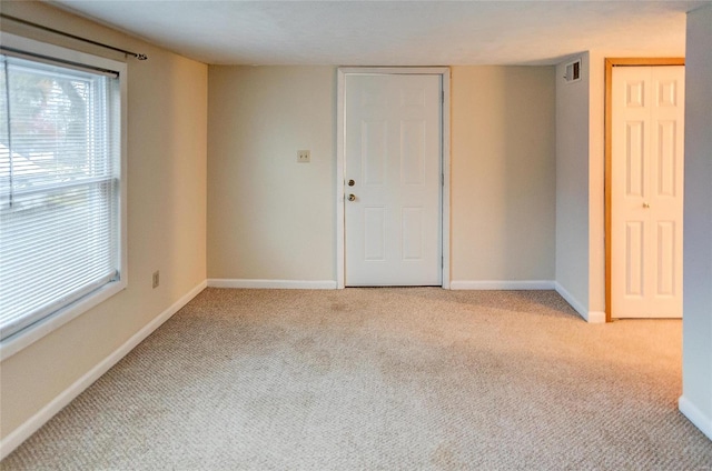 106 N Market St, Waterloo, IL 62298 - unfurnished room with healthy amount of natural light, baseboards, and carpet flooring