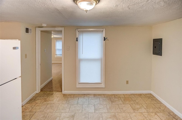 106 N Market St, Waterloo, IL 62298 - spare room with electric panel, a textured ceiling, and baseboards