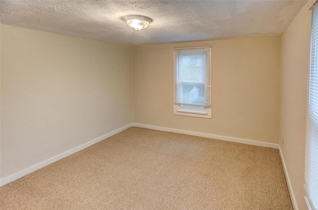 106 N Market St, Waterloo, IL 62298 - unfurnished room with light carpet, baseboards, and a textured ceiling