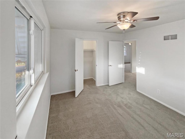 6448 Clifton Hills Dr, Saint Louis, MO 63139 - unfurnished bedroom featuring light colored carpet, a walk in closet, ceiling fan, and a closet